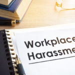 Documents about workplace harassment in an office.