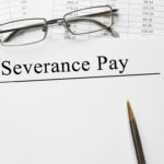 Paper with Severance Pay on a table