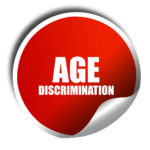 red sticker that reads age discrimination