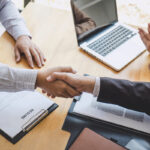 Greeting new colleagues, Handshake while job interviewing, male candidate shaking hands with Interviewer or employer after a job interview, employment and recruitment concept