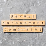 Sexual harassment complaint word written on wood block. Sexual harassment complaint text on table, concept