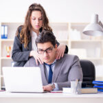 Sexual harassment concept with man and woman in office