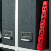 Office shelf with folders and age discrimination law.