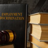 Book with law about Employment discrimination and gavel.