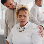 Sexual harassment, touch and uncomfortable with a business man putting a hand on the shoulder of a woman colleague. Exploitation, unprofessional and victimization with an employee touching a coworker