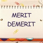 Merit, demerit and its retributions at the level of the individual. MERIT DEMERIT words in a notebook on the table