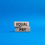 Equal Pay symbol. Wooden blocks with words Equal Pay. Beautiful blue background. Business and Equal Pay concept. Copy space.