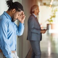 Stressed employee intern suffering from gender discrimination or unfair criticism.